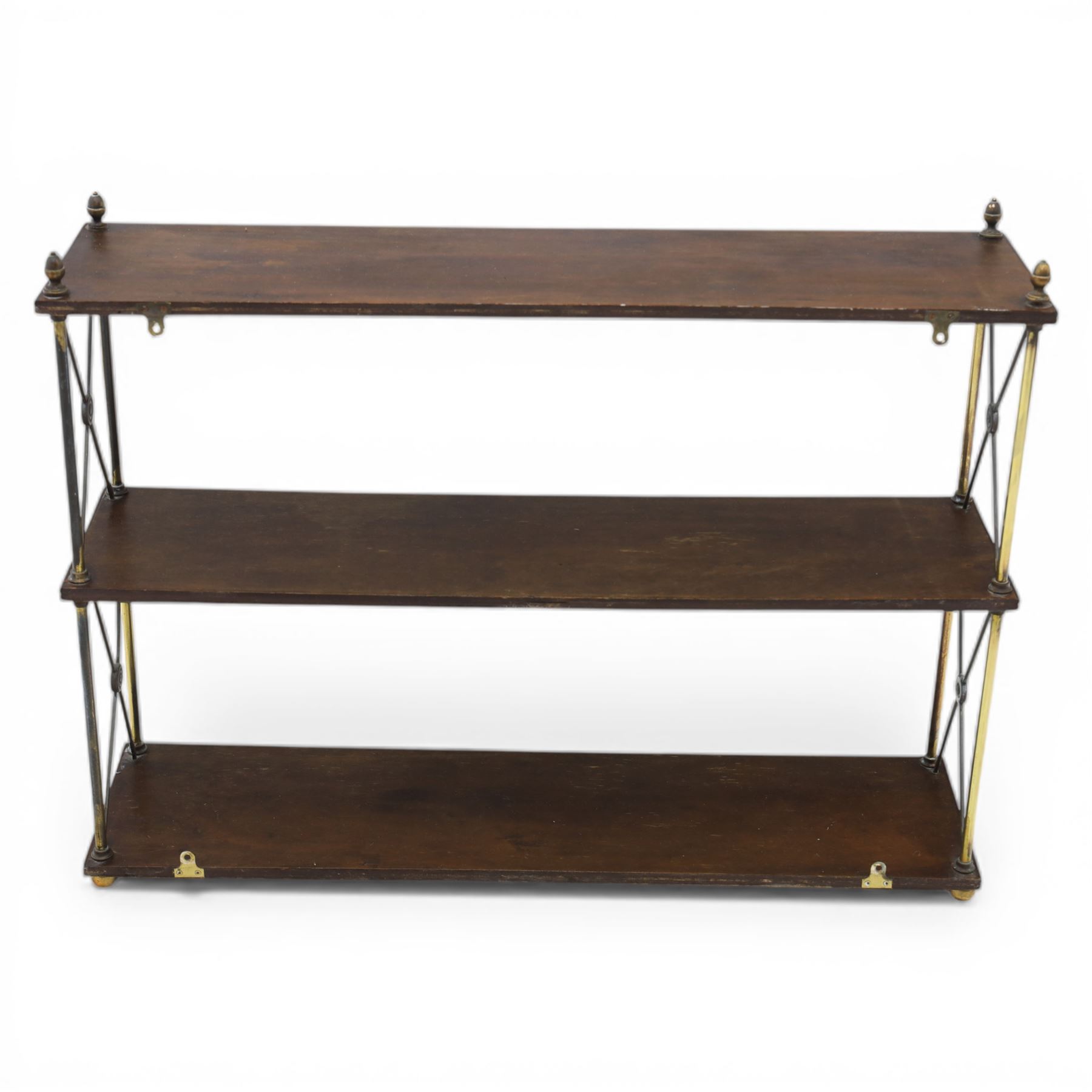 Regency brass and mahogany wall shelves circa 1820, the three shelves contained within a brass cross brace with brass finials, with wall fixings 
