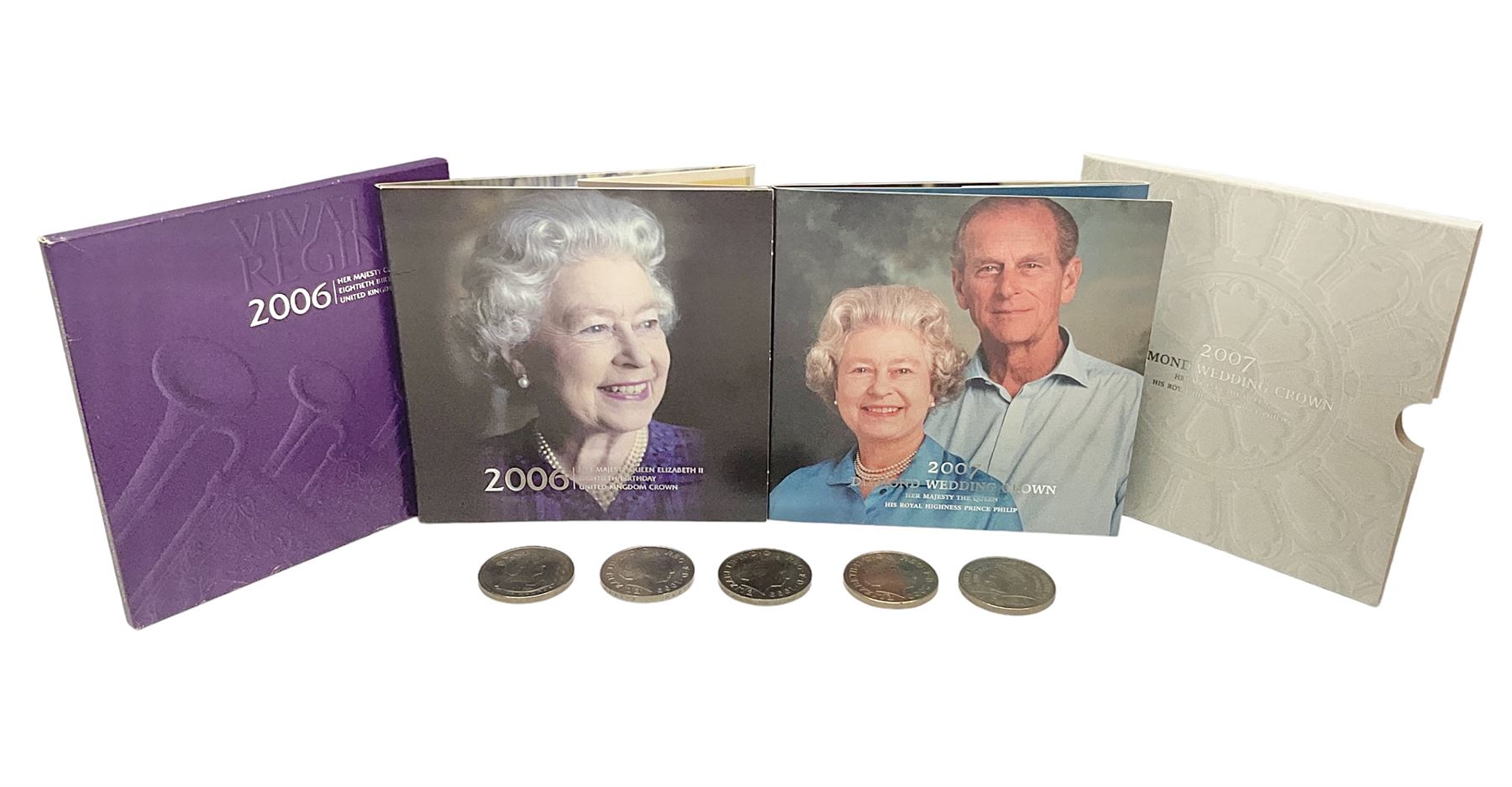 Seven Queen Elizabeth II United Kingdom five pound coins, including 2006 and 2007 in card folders, etc. 