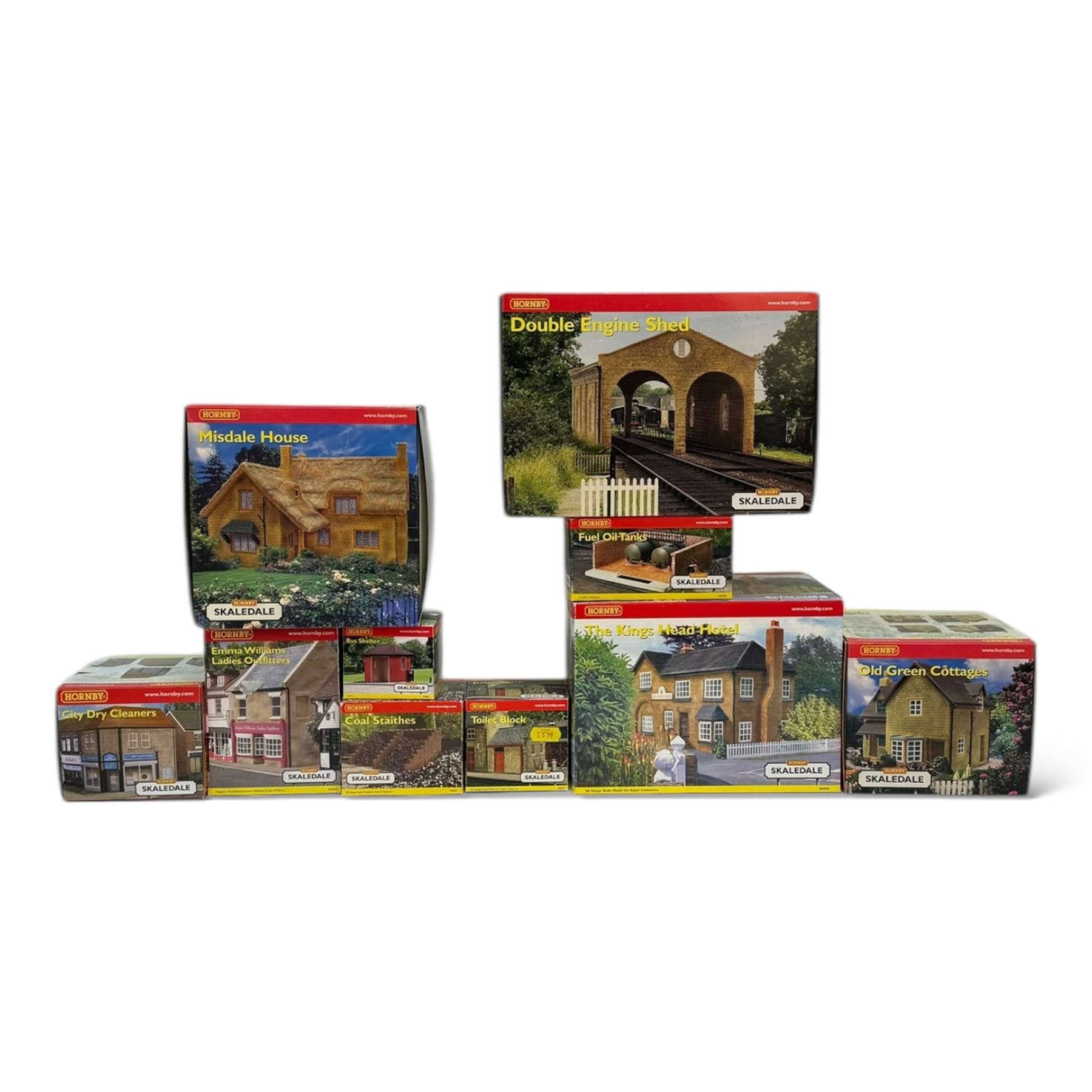 Ten Hornby '00' gauge Skaledale buildings, comprising R8505 The Kings Head Hotel, R8518 Old Green Cottages, R9716 City Dry Cleaners, R9678 Emma Williams Ladies Outfitters, R9800 Bus Shelter, R8637 Double Engine Shed, R8519 Misdale House, R8709 Fuel Oil Tanks, R8630 Toilet Block and R8603 Coal Staithes, all boxed