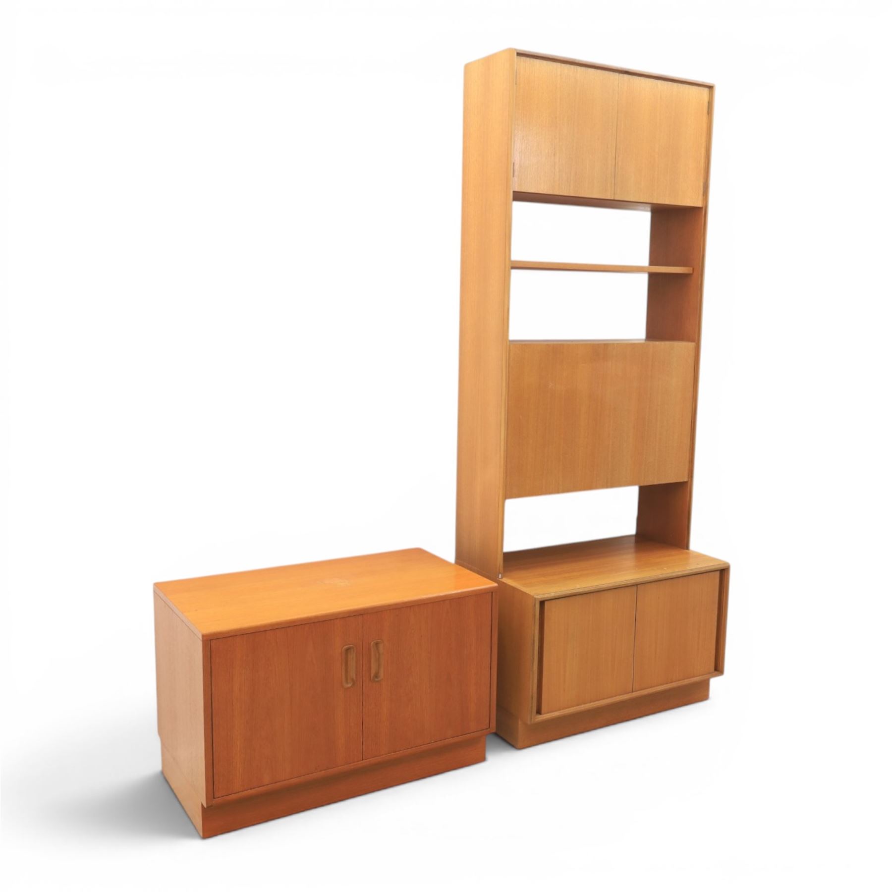 G Plan - Mid 20th century teak units, comprising tall shelving unit with cupboard sections, fall front and open shelves, together with a low twin-door cupboard unit, on plinth bases

Low unit: H 53cm, D 46cm, W 81cm
Tall unit: H 199cm, D 46cm, W 76cm