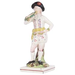 Pair of early 19th century Staffordshire pearlware figures, modelled as musicians, he playing the French horn, she the tambourine, each upon square plinth, tallest example H23cm
