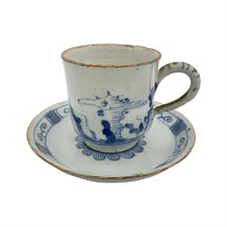 Rare 18th century English delft coffee cup and saucer, circa 1760, probably Liverpool, the cup painted with rockwork, flowers and bird, the saucer painted with central stylised flower head and lattice and scroll border, cup H6cm, saucer D10.5cm