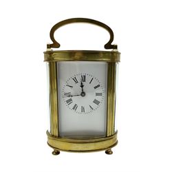 Two French early 20th century timepiece carriage clocks and a traveling case, both clocks with enamel dials, Roman numerals and steel hands, both with cylinder platform escapements.