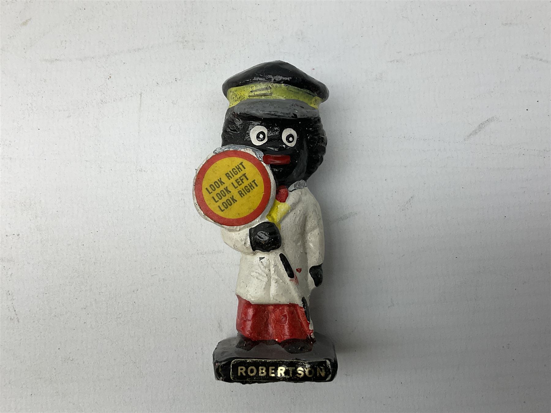 Robinson Jam plaster Golly band, including drummer and singer, H7.5cm

Originally handmade by mothers in Africa for their children from old fabric and cloth, the golly doll was adopted as the mascot and trademark for the Robertson's confectionery brand around 1910 after the company's founder John Robertson visited the US and noticed children playing with them. Robertson's Gollies have been collected by people across the UK and around the world for generations but garnered a contentious image in the 1980s because of links to racism. The trademark was removed from Robertson's branding in 2001.