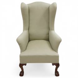 Queen Anne design hardwood framed wingback armchair, upholstered in sage green fabric, on shell carved ball and claw feet