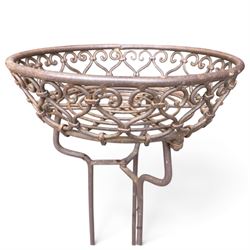 Three wrought iron garden basket planters, comprising a circular pierced and scrolling basket on tall tripod stand with scrolling supports (W31cm H76cm), and a pair of matching hanging baskets (W37cm H30cm)