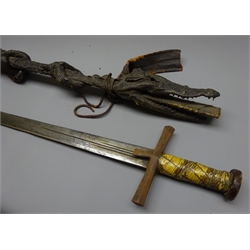  Sudanese Kaskara Sword, 74cm broad double edged part fullered blade engraved with opposing moons, crocodile skin bound wooden grip and iron cross guard, in full crocodile skin covered scabbard, L115cm max  