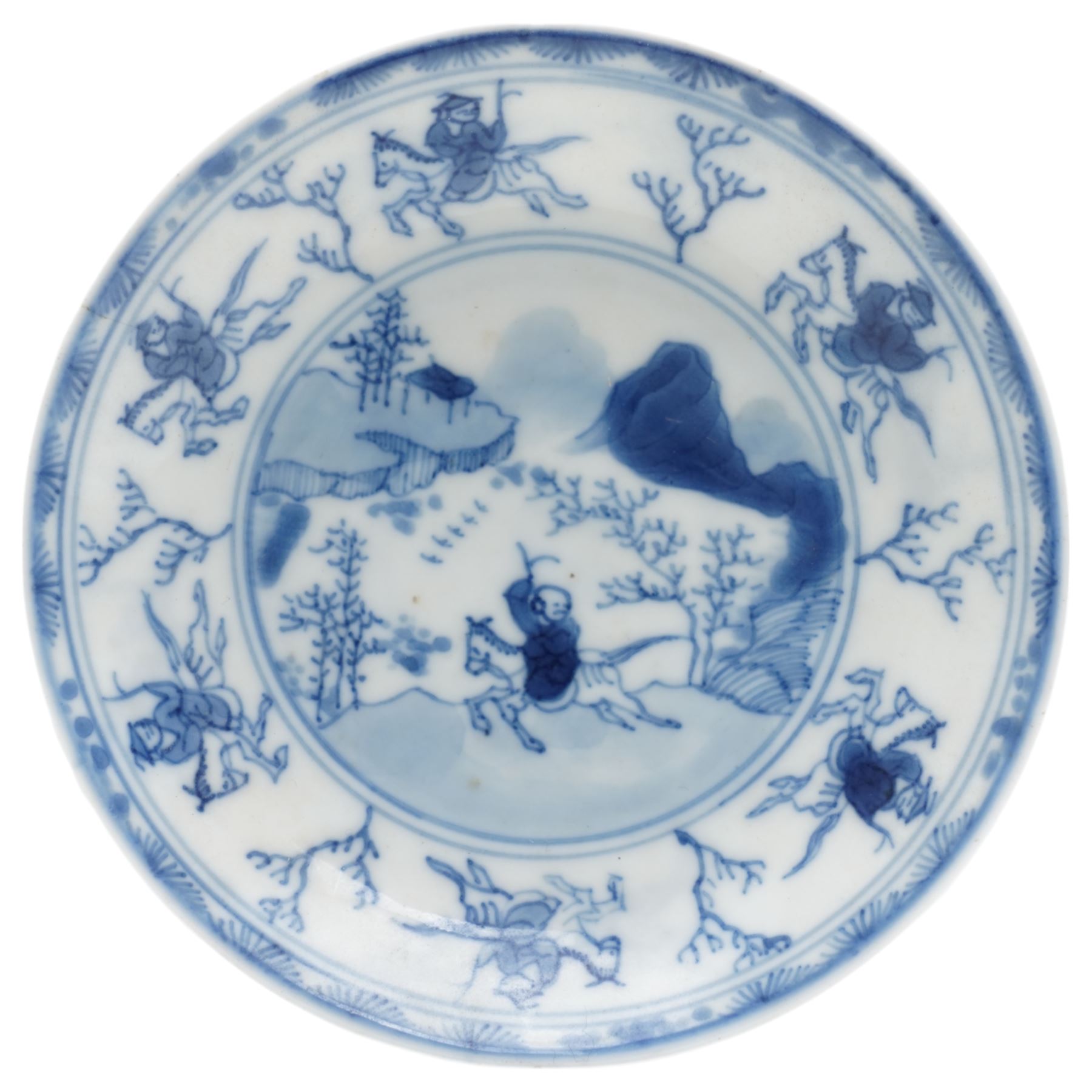 Chinese Kangxi period blue and white saucer, decorated with a hunter in a landscape, the boarder decorated with hunters and branches, D10cm