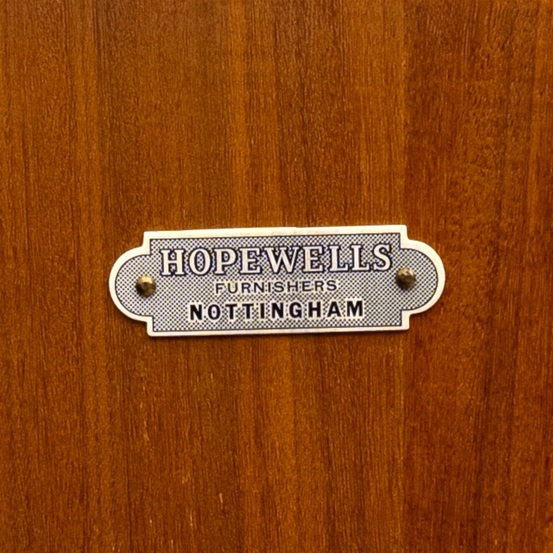 Richard Hornby for Fyne Ladye - mid-20th century afromosia teak sideboard, retailed by Heals of London, rectangular form, with low profile carved gallery lip, above three central drawers with ribbed drawer fronts, flanked by two cupboards with vertically grained doors and recessed pull handles, with streamlined moulded edges and sides, raised on tapered slender legs 