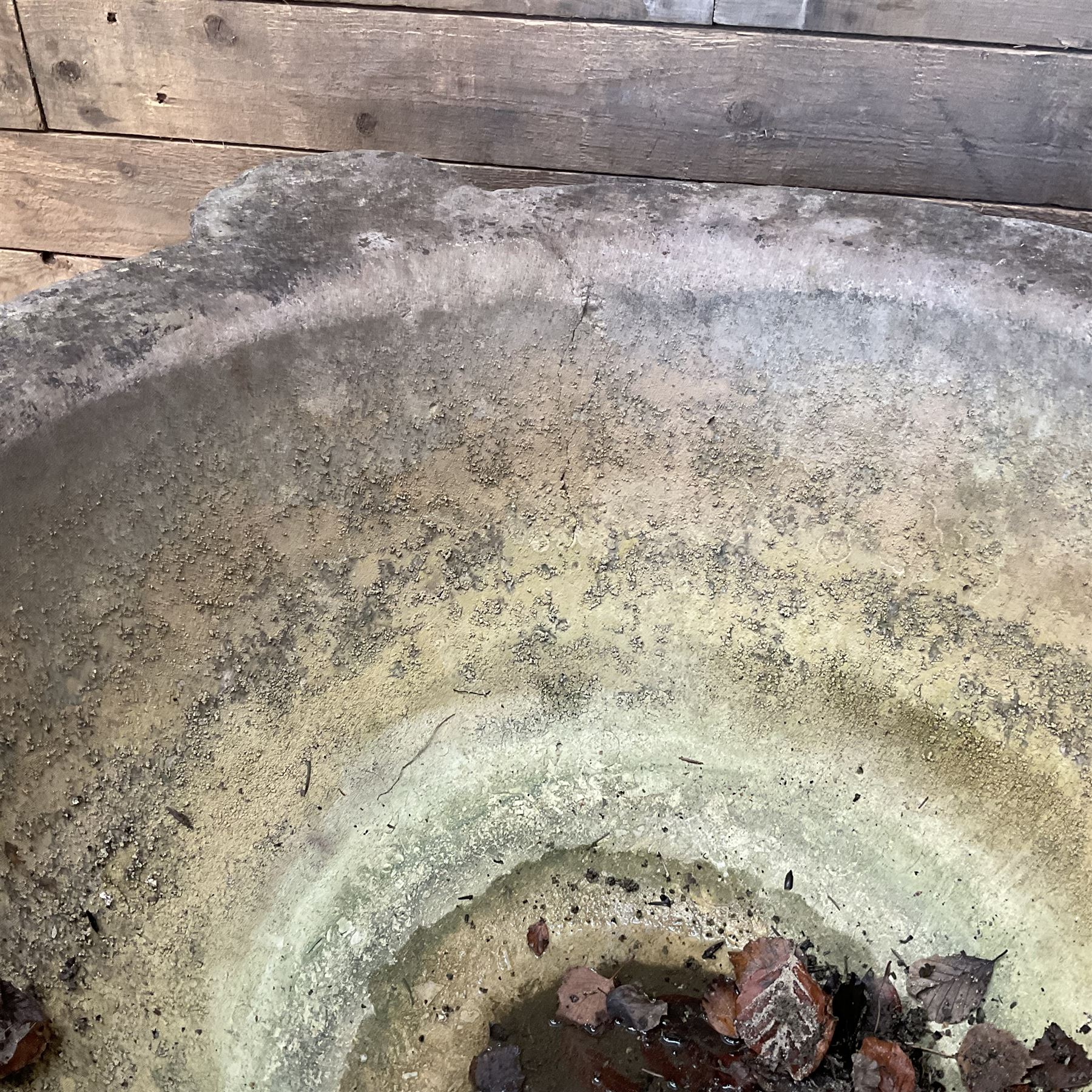 Large 19th century circular stone mortar planter on wrought iron stand