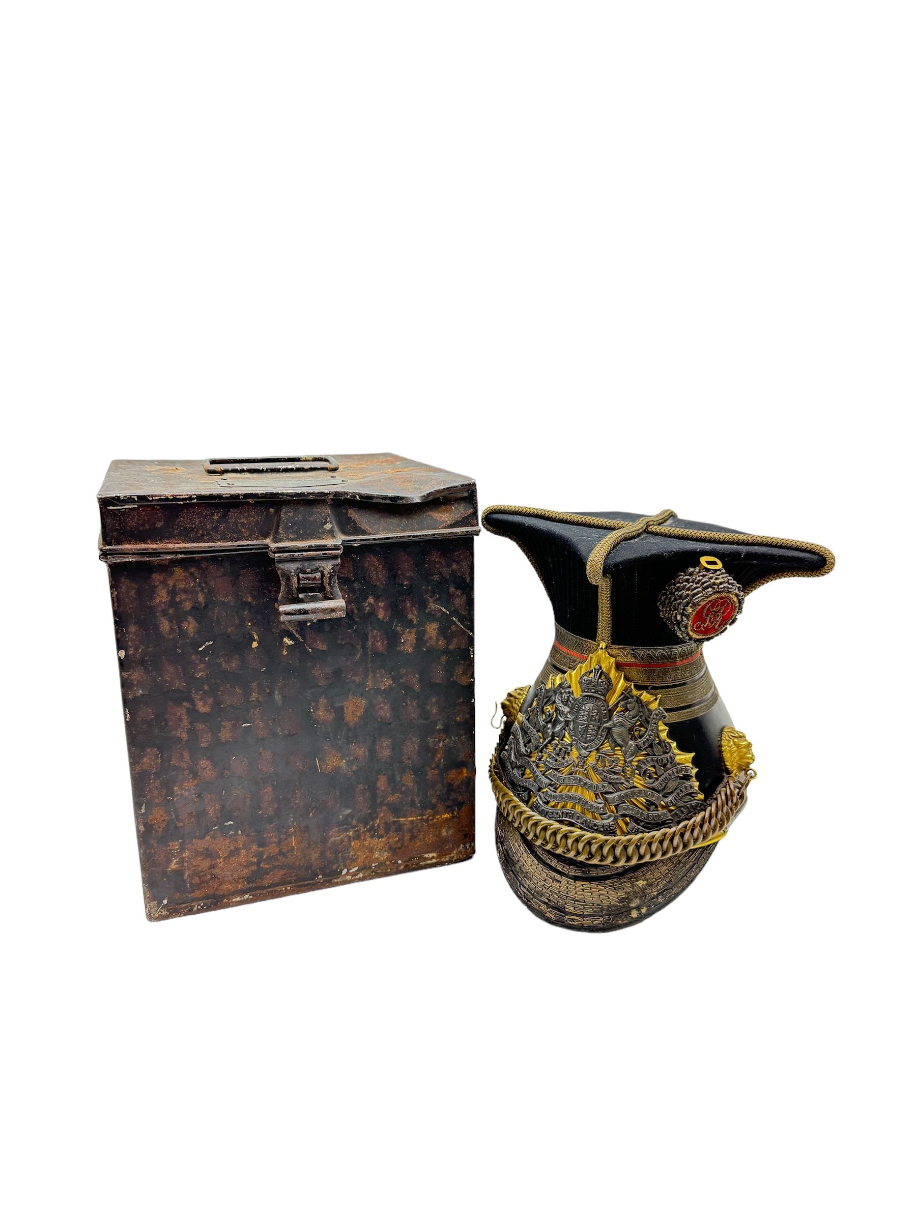 16th Queens Lancers Officers Lance Cap, black leather body with gilt braid lace and gilt wire braiding to the peak, officers silver gilt helmet plate to the front, the black cloth mortar board top with thick bullion wire, the bullion socket holder with embroidered GR cipher to the centre, lion head side bosses with velvet backed linked chinstrap, interior with leather sweatband and cloth lining, marked Carter & Co Pall Mall, the helmet is housed in japanned storage tin with brass plaque engraved “Lieu H L Evans, 16th Lancers'