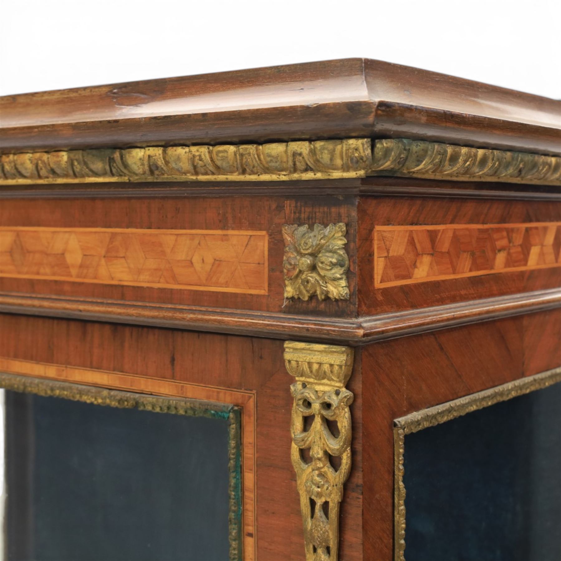 French kingwood display vitrine, rectangular glazed case with baized lined interior, parquetry banding and gilt metal bead mounts, applied gilt metal foliate corner mounts, raised on turned supports united by shaped undertier stretchers