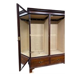 George III mahogany double wardrobe, the projecting cornice with dentil moulding over two panelled doors with mirror-lined interiors, enclosing hanging rails and brass hooks, the base fitted with two drawers, raised on bracket feet