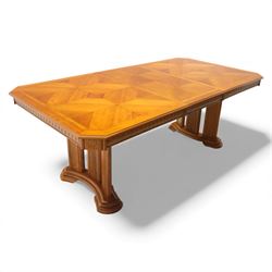 Late 20th century parquetry veneered extending dining table and eight chairs, the rectangular top with canted corners decorated with geometric parquetry panels, moulded edge frieze with repeating carved detail, raised on twin pedestal supports with fluted columns and shaped platform bases, the chairs with pierced splat backs and upholstered drop-in seats
Extends on a central leaf to 208cm