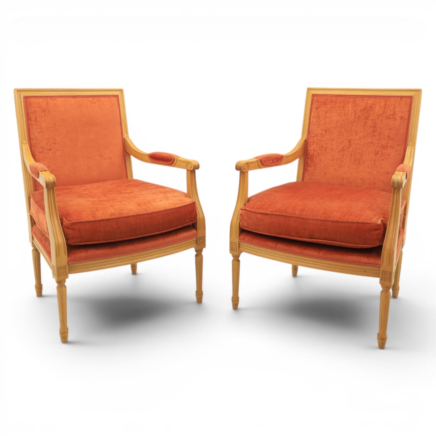 Pair of mid-20th century beechwood fauteuil armchairs, upholstered backrest and seat in terracotta velvet fabric, padded armrests with scroll detail, on tapered fluted supports with carved floral rosette blocks (very modern and not a desirable timber)