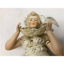 Late 19th century continental spill vase as a young girl standing beside an open tree trunk H21cm; and three German bisque figures (4)
