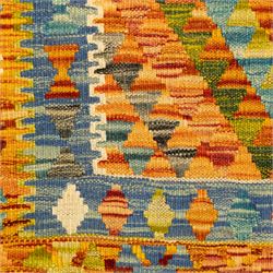 Two Chobi Kilim flatweave rugs, comprising the largest kilim on a cream ground with a grid of stepped diamond medallions in a palette of rust red, turquoise, green, ochre, and lilac,, filled lozenge motifs, framed by a cream ground border, 148x101cm, Chobi Kilim with multi-stepped diamond medallion with serrated bands, in terracotta, turquoise, green, saffron and blue, framed by a broad polychromed border of stylized guls and narrow guard stripes, 114x87cm 