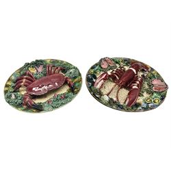 Two 20th Century Portuguese Palissy style Majolica wall plates, one depicting a crab, the other a lobster each to the centre modelled in relief surrounded by encrustations and shells, both with impress marks beneath, D34cm