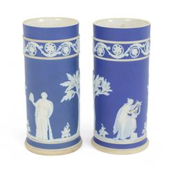 Early 20th century Wedgwood Jasperware vase, of baluster form with fluted rim, decorated with floral swags united by goat masks on a dark blue ground, together with a pair of Wedgwood jasperware spill vases, tallest H24cm