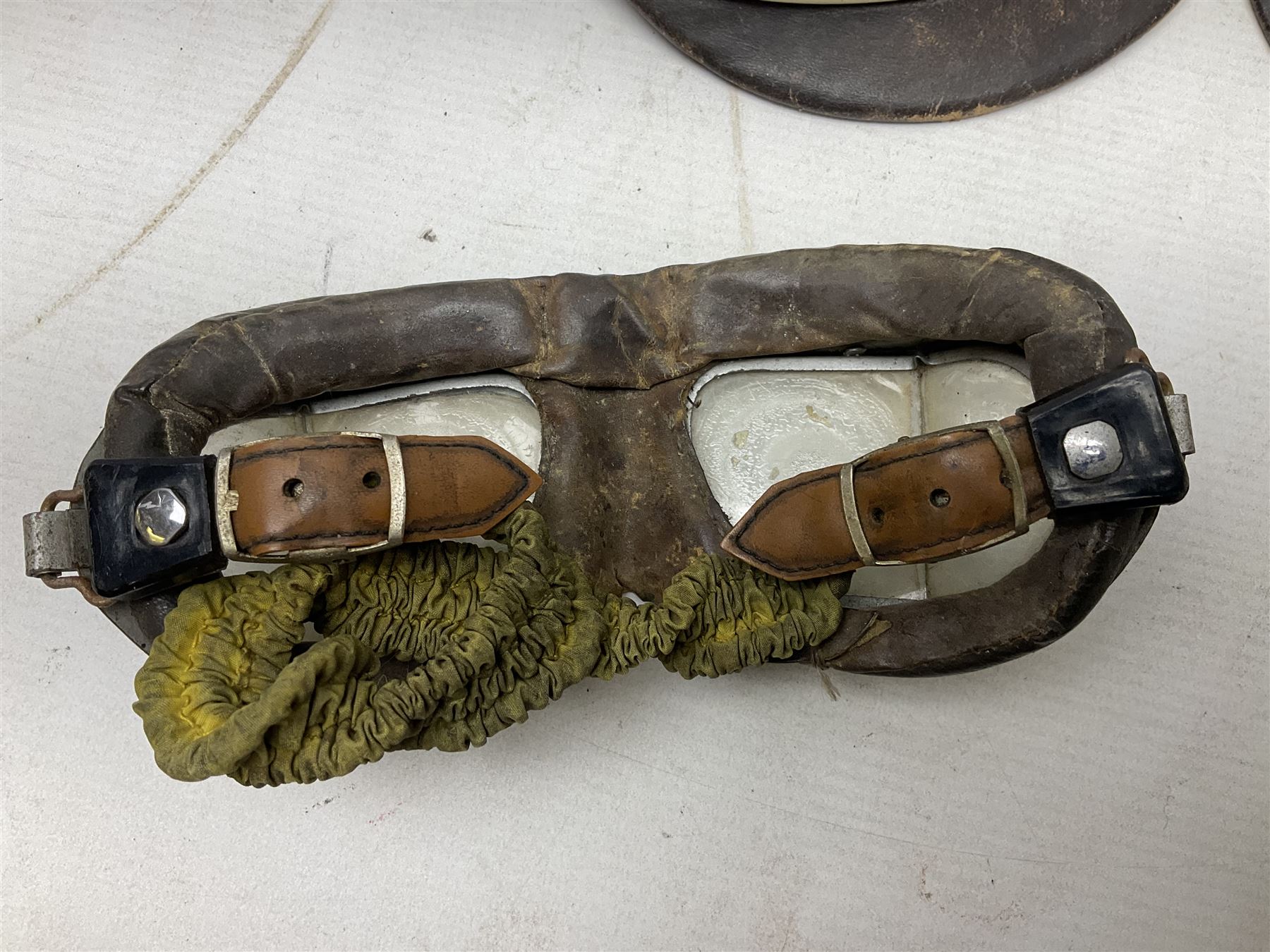 Two Geno Paris small size motorcycle helmets; and three pairs of goggles, one marked 'Stadium'