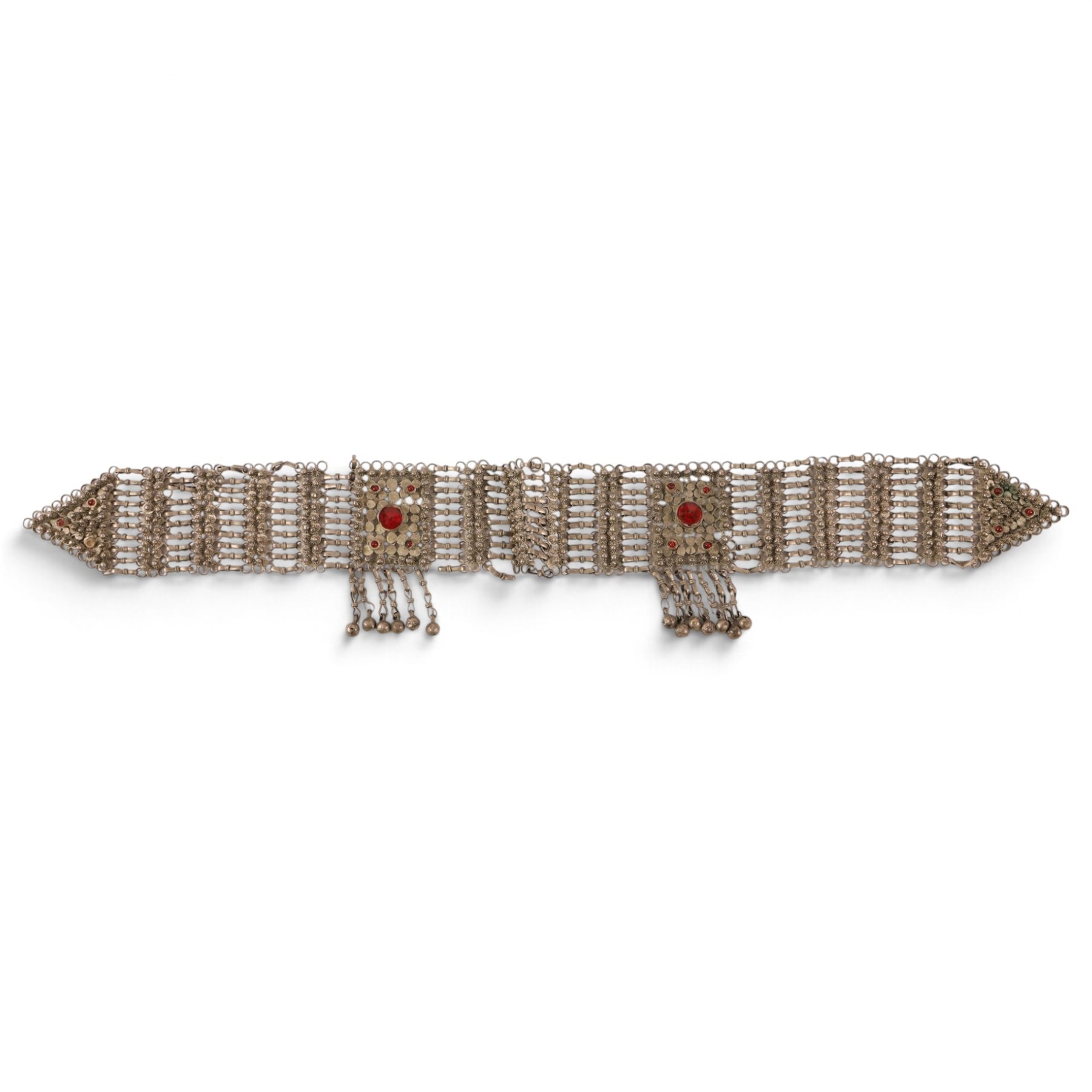 Collection of Middle Eastern jewellery, including silver necklace with a crescent  shaped pendent with beadwork and barrel tasselled ends, nickel silver wedding necklace with filigree decoration, coin bracelet, two bridal wedding caps and two others 