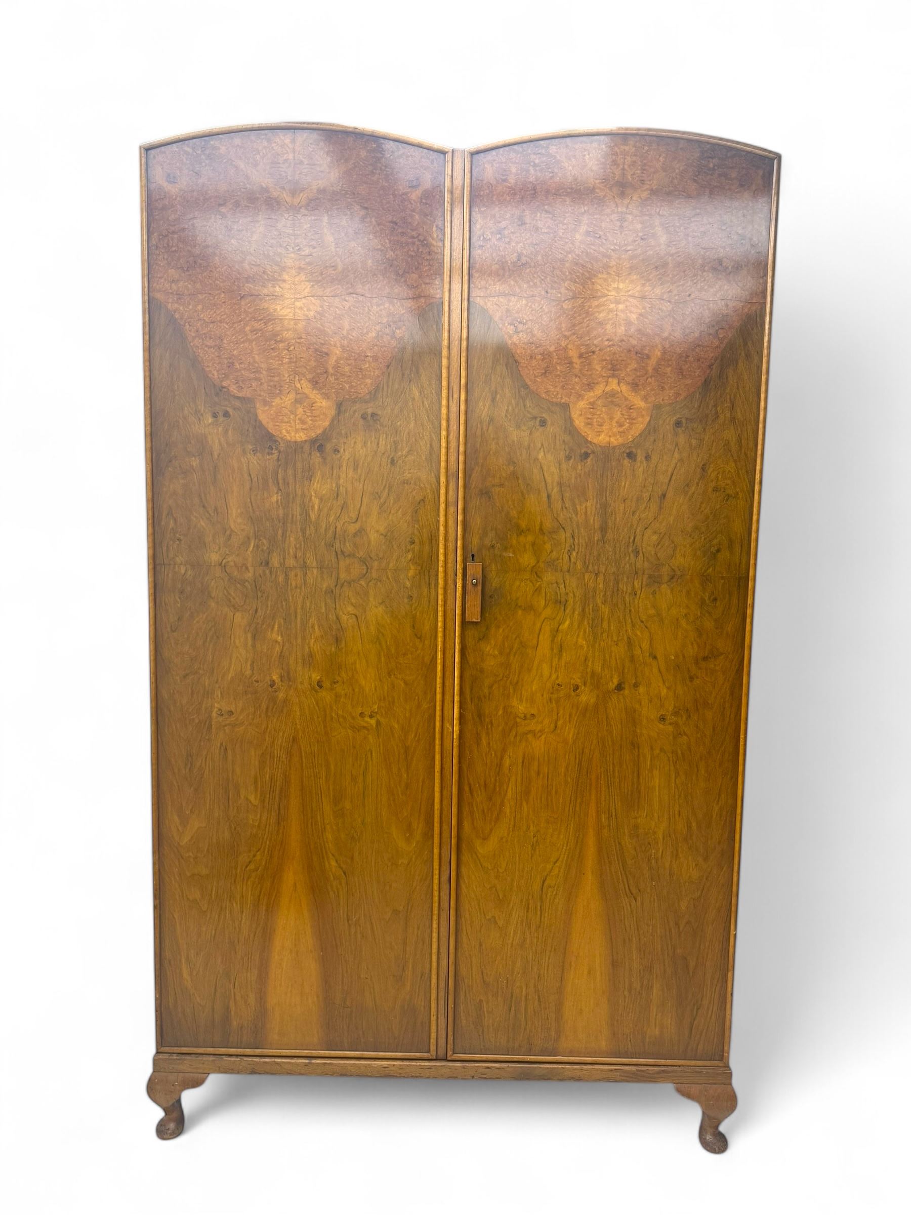 Ashton Leach & Cumberbirch Ltd., Rochdale - early 20th century walnut and mahogany gentleman's wardrobe, arched moulded top with book-matched figured walnut veneers, double doors enclosing fitted interior with hanging rail, tie rack and drawers, raised on cabriole supports