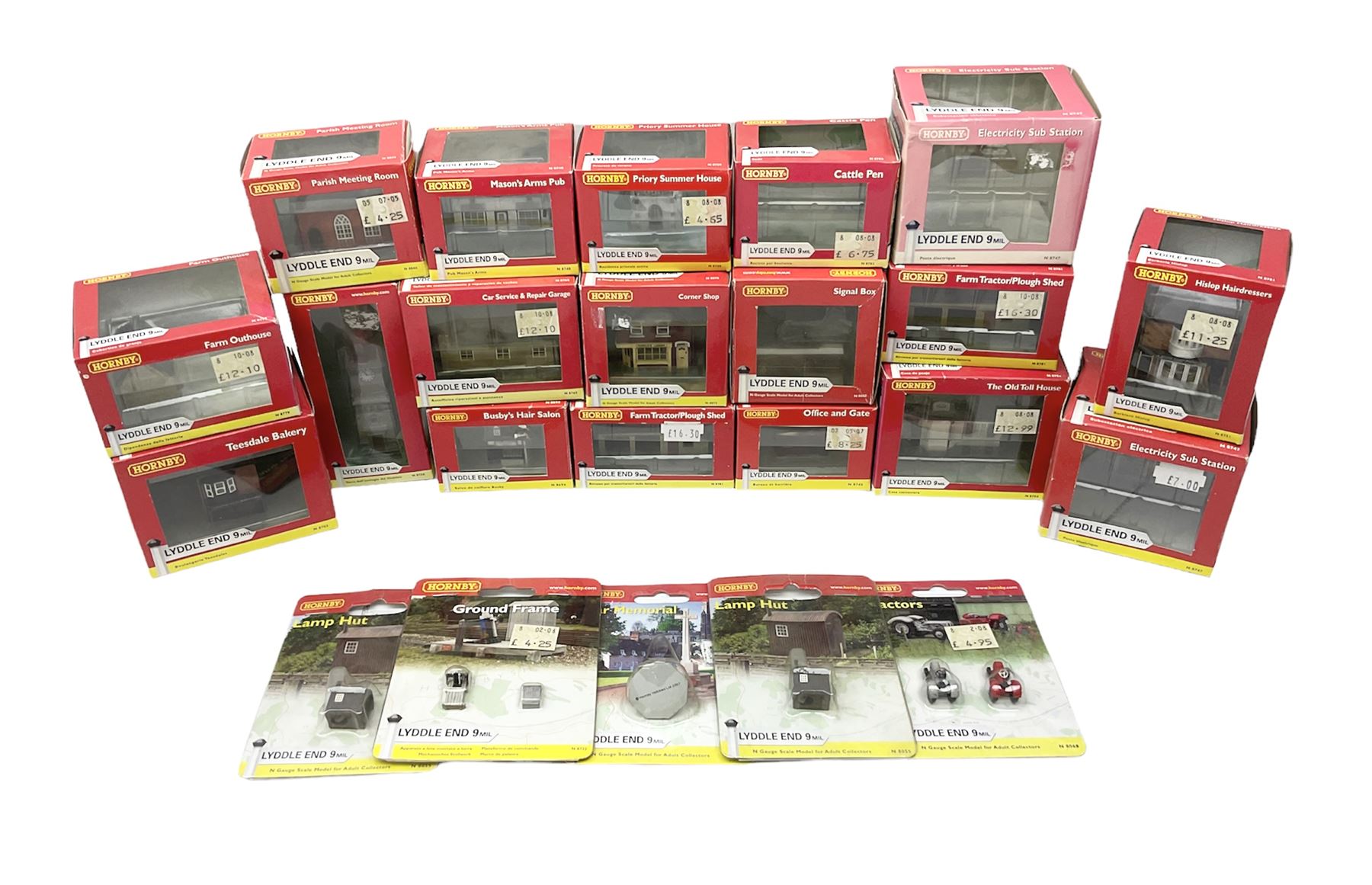 Hornby 'N' gauge - eighteen Lyddle End trackside buildings including The Old Toll House, Electricity Sub Station, Teesdale bakery, Mason's Arms Pub, various shops and hairdressers, farm buildings, Clock Tower etc; all boxed; and five Lyddle End blister pack cards of trackside accessories including Lamp Huts, Tractors, War memorial etc (23)