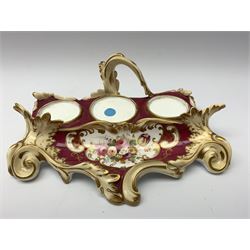 19th century desk stand, possibly Minton, of scrolling form the tray hand painted with floral spray before twin lidded inkwells flaking a central candlestick/taper stick, with pattern number beneath 6355, L21.5cm