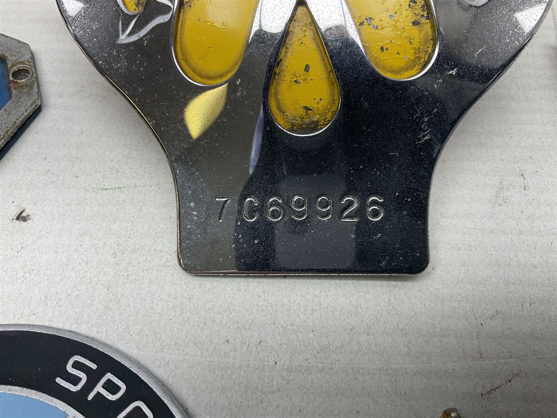 Four car badges, comprising two RAC, AA and a Morgan Sports Car Club example, together with a Royal Coat of Arms plaque (5)