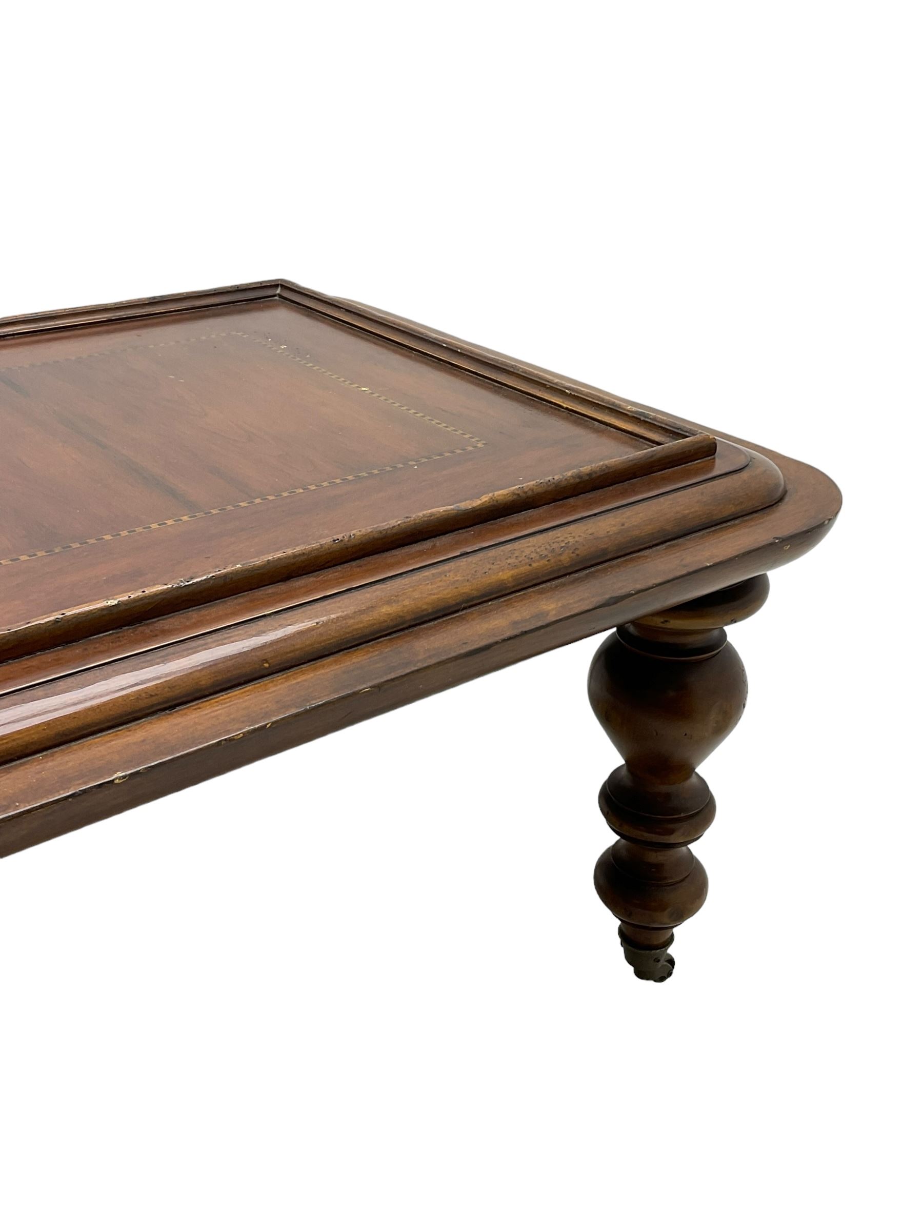 Milling Road - cherry wood coffee table, rectangular top with rounded corners, on turned feet with castors