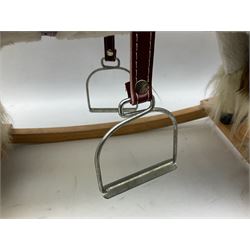 Modern plush covered rocking horse with inset eyes, simulated leather bridle and saddle with metal stirrups, on curving wooden rockers L94cm H64cm