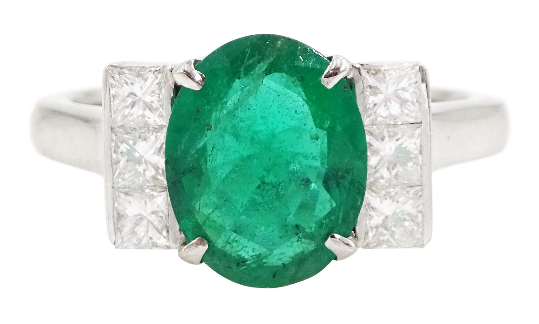 18ct white gold emerald and diamond ring, single oval cut emerald, each side set with three princess cut diamonds, stamped 750, emerald approx 1.90 carat, total diamond weight approx 0.50 carat