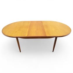 G Plan - mid-20th century teak extending dining table, oval top with integrated extension leaf, raised on tapering legs, together with a set of six slat back dining chairs including two carvers, upholstered in dark green velour (Extends to 210cm)