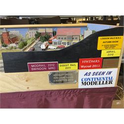 'Z' gauge continental scenic layout with folding legs, various loops of track and sidings with overhead cables, buildings including water tower, tunnels, roads with motor vehicles and figures, trees, haven with boats, backdrop diving wall hiding control units 150 x 50cm