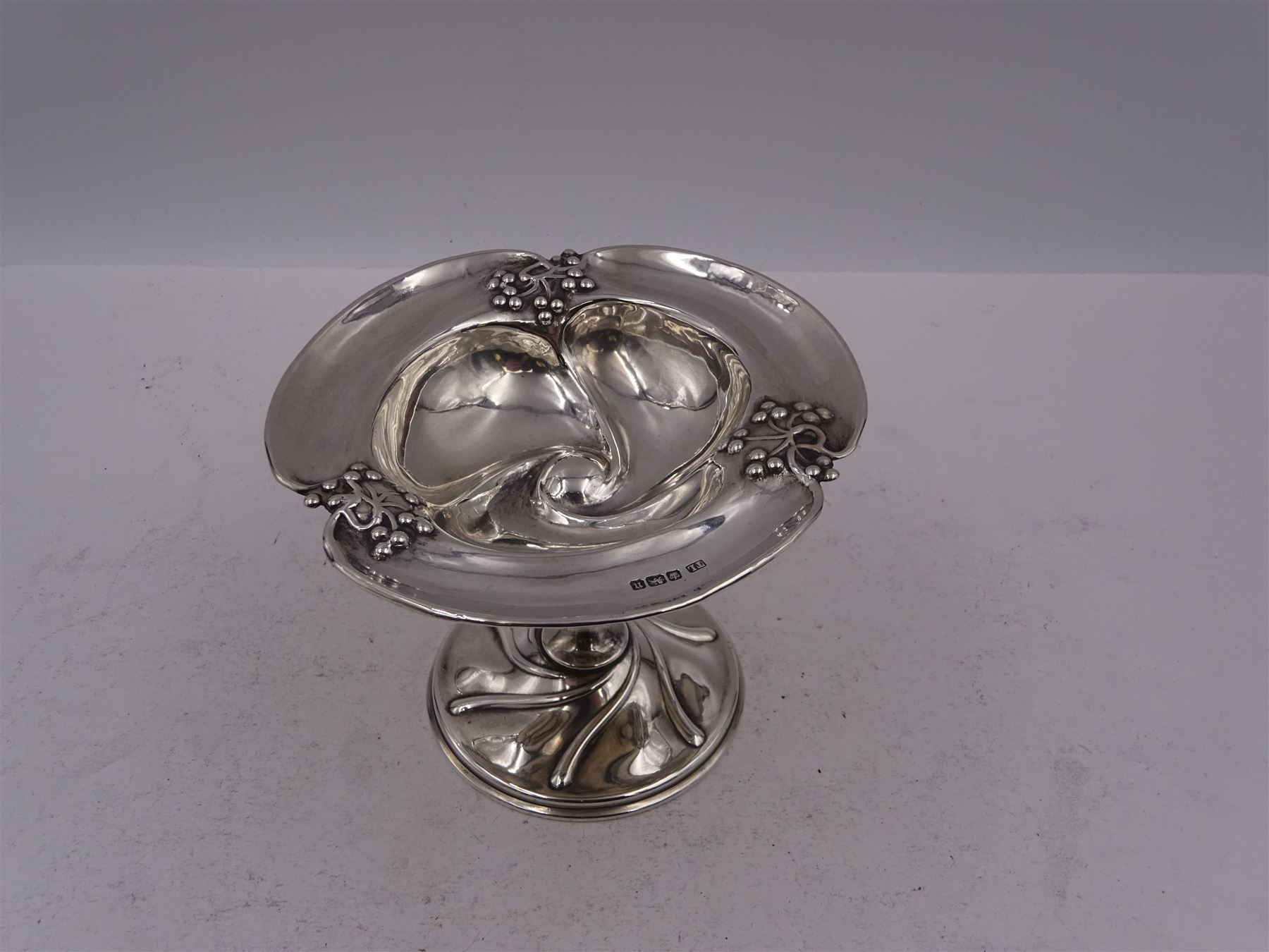 Art Nouveau silver bon bon dish, the bowl of trefoil form embossed with fruiting vines to the rim, upon a knopped pedestal and domed circular foot, hallmarked Levesley Brothers, Sheffield 1905, H8.8cm