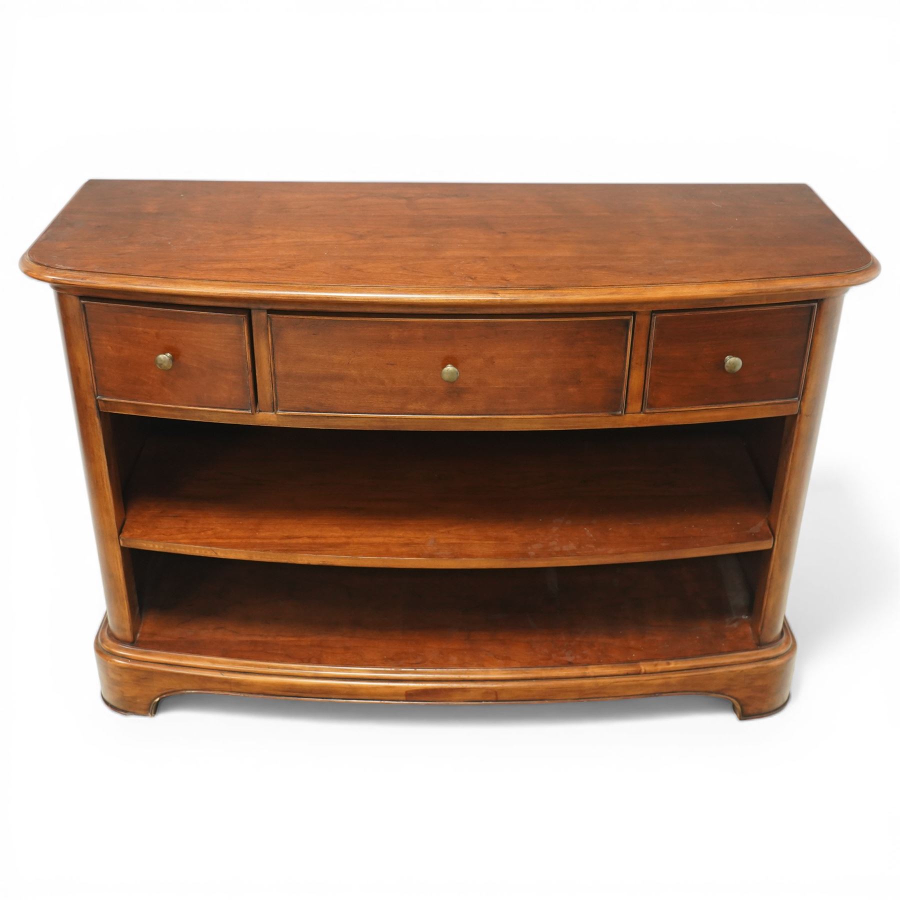 Willis & Gambier - curved sideboard, curved rectangular top, above three frieze drawers with brass pulls over two open recesses, on bracket feet 