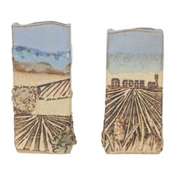 Robin Gough; two studio pottery vases of rectangular chimney vase, each decorated in relief with villages, H15cm 