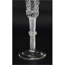 Late 18th/early 19th century drinking glass, the bell shaped part cut bowl engraved with husk swag, patera and urns, upon a single series air twist triple ring knopped stem and conical foot with ground pontil, H17cm