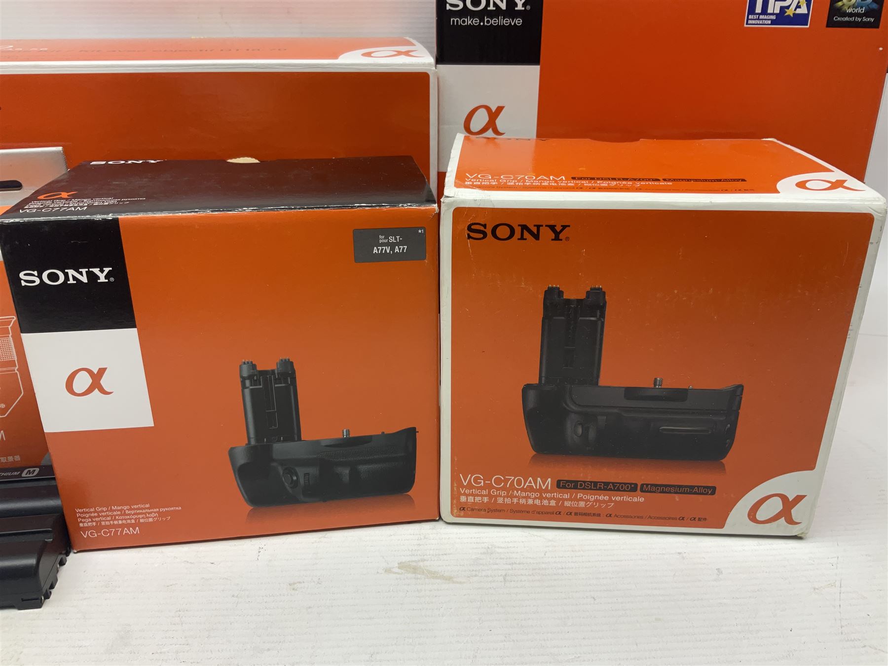 Sony Alpha A700 camera body, serial no 2340937, Sony Alpha A77 camera body, serial no 0715406, together with Sony angle finder and two firm holding grips, all with original boxes  