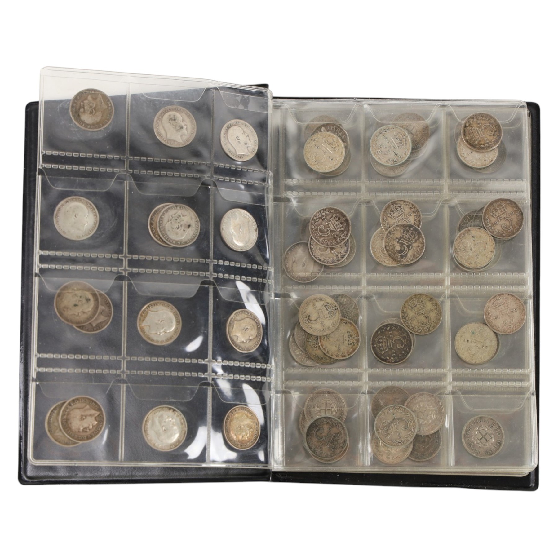 Approximately thirty-two Great British pre-1920 and approximately forty Great British pre-1947 silver threepence coins, in black folder