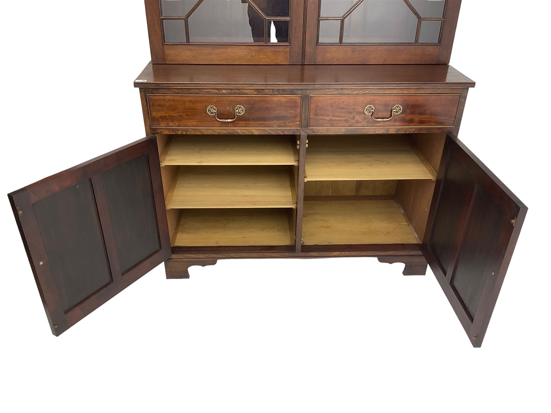 Acorn Industries - Georgian design mahogany bookcase on cupboard, fitted with two astragal glazed doors enclosing three glass shelves, base with two cock-beaded drawers over two panelled cupboards, inlaid with acorn signature, by Alan Grainger, Brandsby