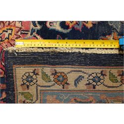 Vintage Persian Tabriz indigo ground rug, the central floral medallion within a field woven with scrolling palmettes and plant motifs, with contrasting spandrels, the the cyan guard lines with scrolling floral patterns