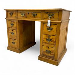Rustic pine twin pedestal desk, rectangular green leather inset top above a central frieze drawer flanked by two short drawers, each pedestal featuring three graduated drawers, raised on a plinth base
