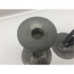 Pair of Solkets English pewter candlesticks, the bud shaped sockets raised upon three angular fin supports and a slightly domed circular base with cast stylised foliate decoration, H23cm