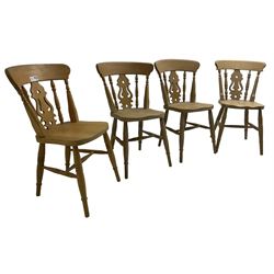 Set of four 20th century beech farmhouse kitchen chairs, pierced shaped back splat over saddle seat, raised on ring turned supports joined by H-stretcher