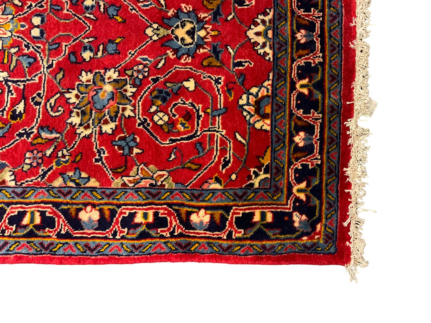 Central Persian Kashan crimson ground runner rug, the field decorated with interlacing branch and stylised flower head motifs, the guarded indigo border with repeating trailing foliate patterns