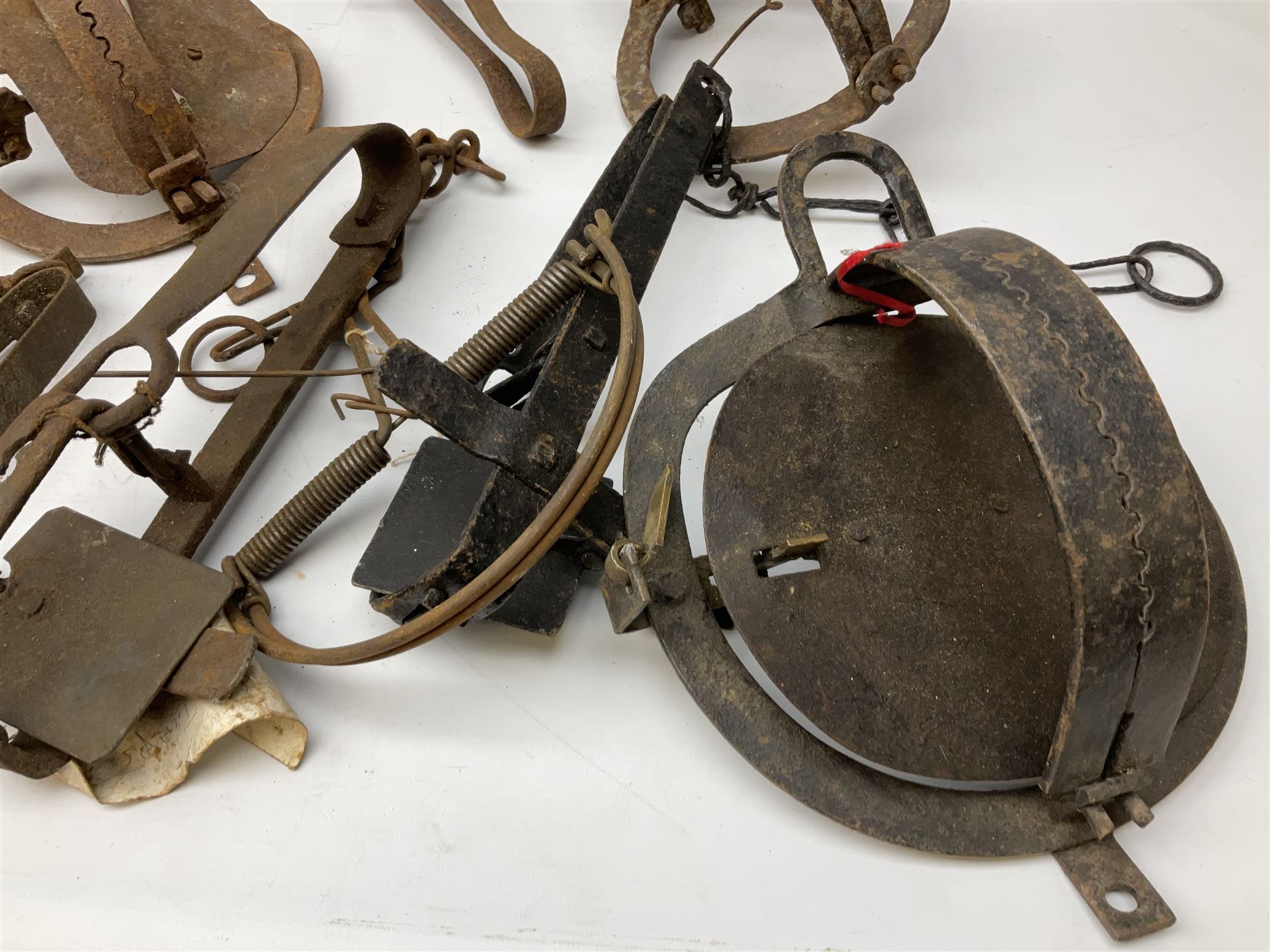 Quantity of animal traps including, gin traps, mole traps, Henri Marty wirework cage trap etc. Auctioneer's Note: These traps are sold as artefacts for ornamental purposes only as the use of some of them is illegal.