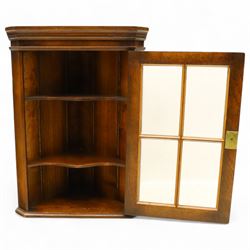 Early 20th century oak wall-mounted corner cabinet, moulded cornice above a single glazed door with six-panel astragal glazing, fitted interior with two shaped shelves