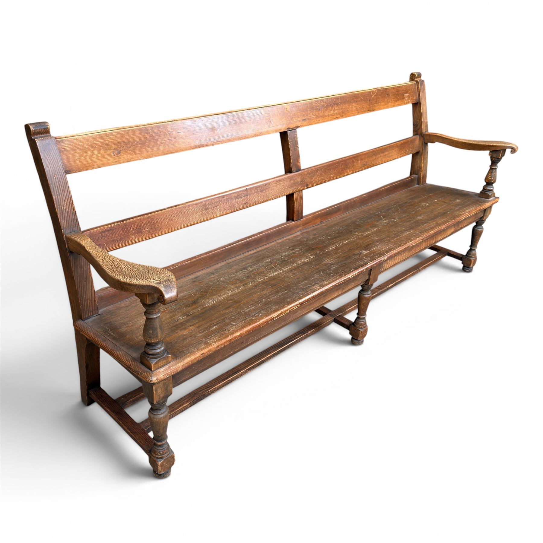 Early 20th century pine and oak bench seat, stained pine rail back frame with shaped oak arms