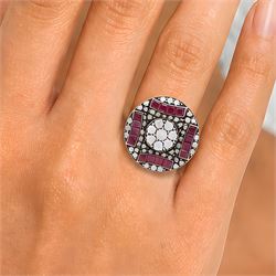 Rose gold and silver ruby and diamond circular ring, the central cluster set with eight round brilliant cut diamonds, with calibre cut ruby and single cut diamond surround, total diamond weight approx 0.90 carat, total ruby weight approx 0.75 carat